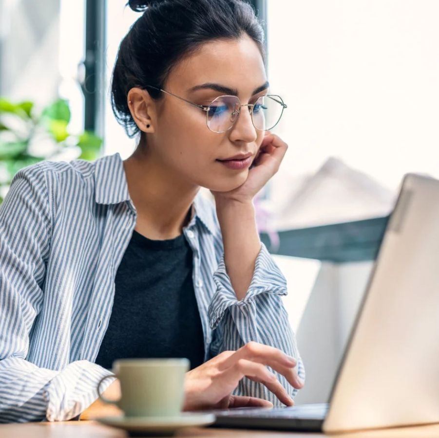 Working woman in office drinking coffee in the morning